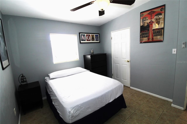 tiled bedroom with ceiling fan and baseboards