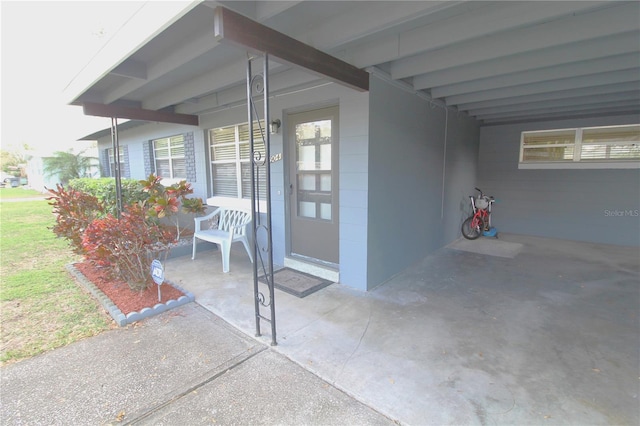 view of patio / terrace featuring a carport and a porch