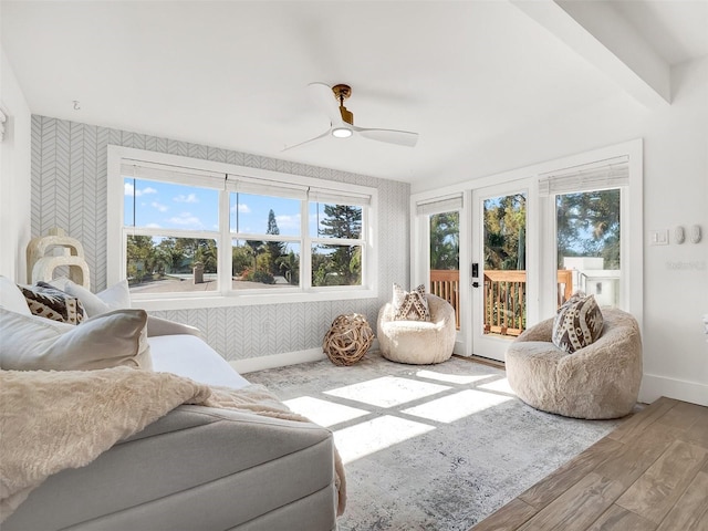 sunroom / solarium featuring a ceiling fan, plenty of natural light, and french doors