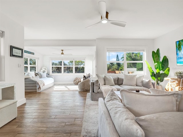 living room with ceiling fan and wood finished floors