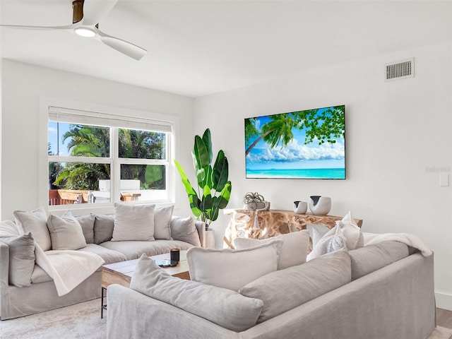 living room with visible vents and a ceiling fan