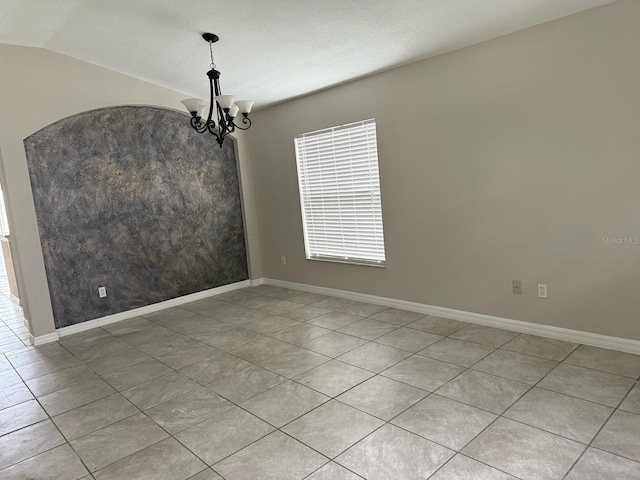 unfurnished room featuring lofted ceiling, a notable chandelier, and baseboards