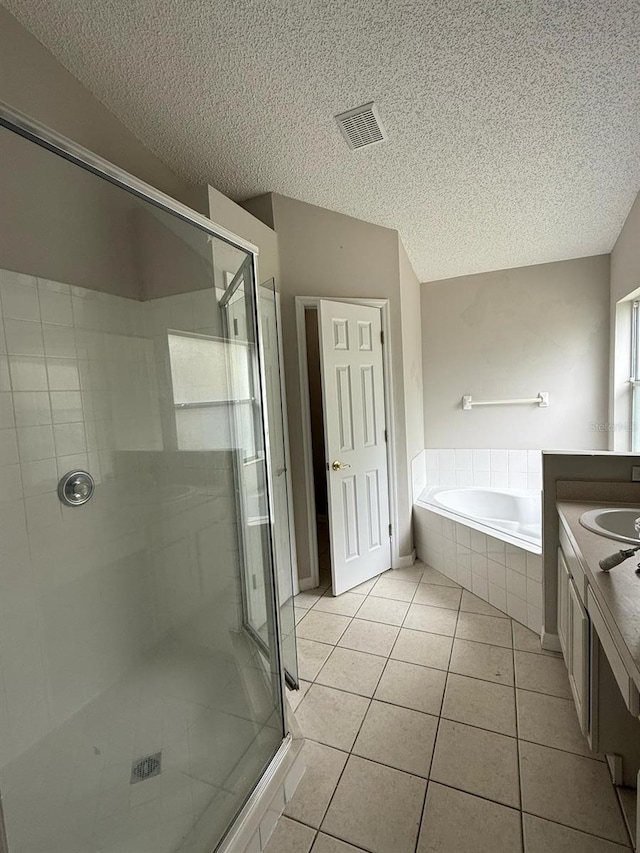 full bath with tile patterned floors, visible vents, a garden tub, a shower stall, and vanity