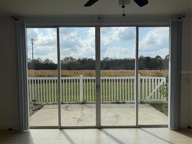 unfurnished sunroom featuring ceiling fan