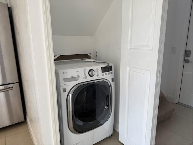 laundry area with laundry area, washer / clothes dryer, and light tile patterned flooring