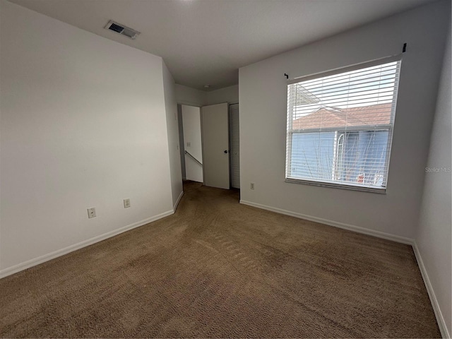 unfurnished bedroom featuring visible vents, carpet flooring, and baseboards