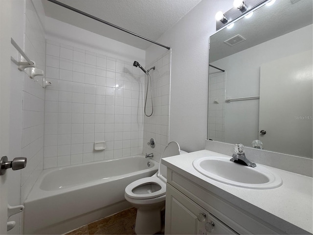 bathroom featuring visible vents, tub / shower combination, toilet, vanity, and a textured ceiling