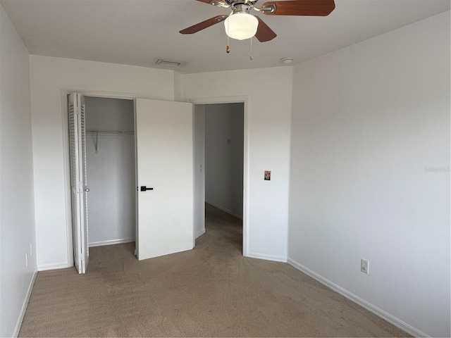 unfurnished bedroom with a ceiling fan, baseboards, a closet, and carpet floors