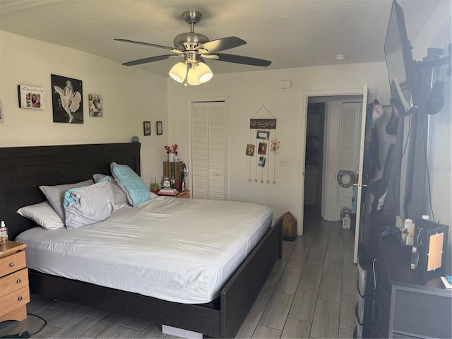 bedroom featuring a closet, a ceiling fan, wood tiled floor, and a textured ceiling