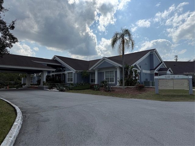 view of front of property with central AC unit and driveway