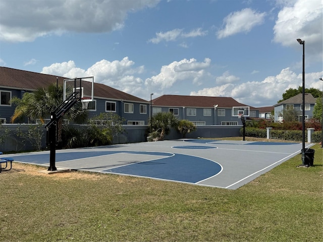 view of sport court featuring community basketball court, a lawn, and a residential view