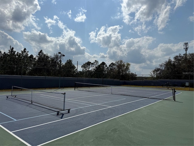 view of sport court with fence