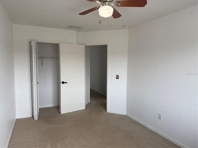 373 Caribbean Dr, Davenport, FL 33897 - unfurnished bedroom featuring carpet, baseboards, a closet, and a ceiling fan