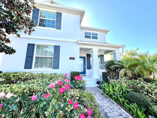 view of front of home with a porch and stucco siding