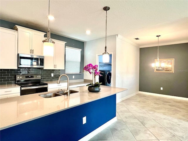 kitchen with a sink, stainless steel appliances, white cabinets, decorative light fixtures, and tasteful backsplash