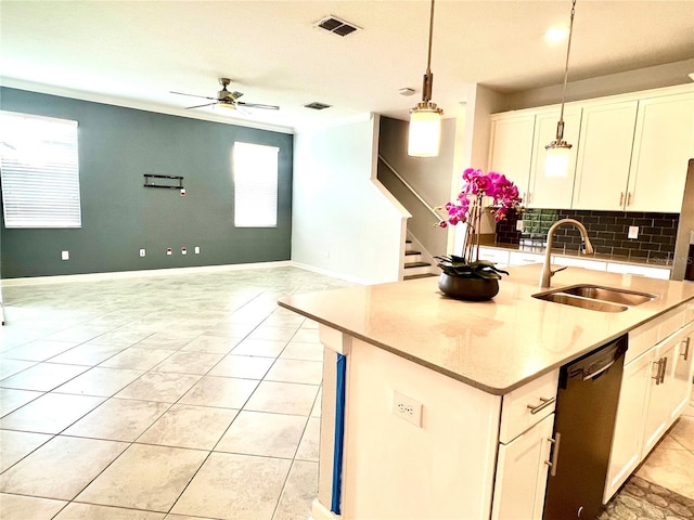 kitchen featuring visible vents, a sink, backsplash, dishwashing machine, and a healthy amount of sunlight