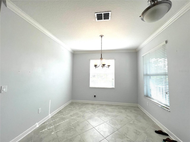 empty room featuring visible vents, ornamental molding, a textured ceiling, baseboards, and a chandelier