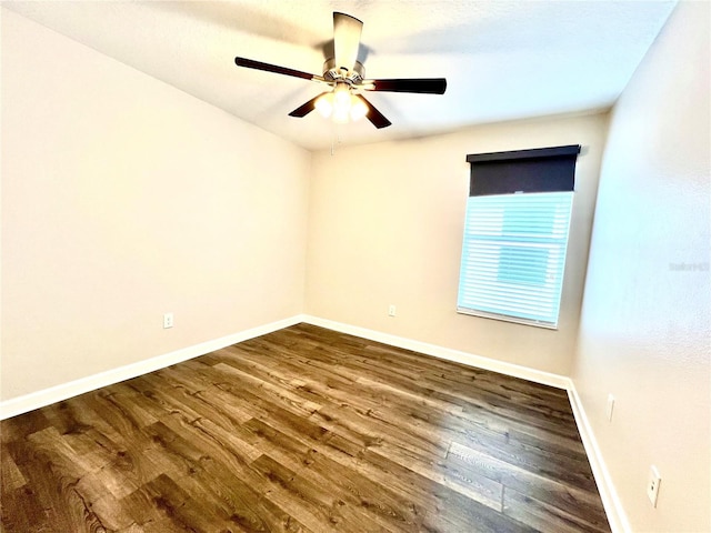 empty room with wood finished floors, baseboards, and ceiling fan