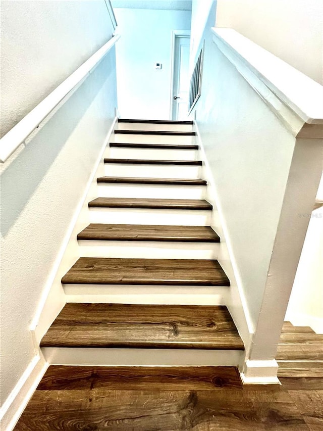 stairs with baseboards and wood finished floors