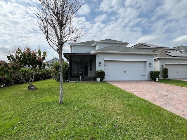 view of front of property with a front lawn, decorative driveway, an attached garage, and stucco siding