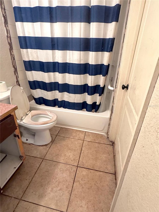 bathroom with tile patterned floors, toilet, and shower / tub combo with curtain