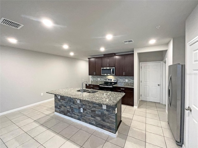 kitchen with visible vents, appliances with stainless steel finishes, decorative backsplash, and a sink