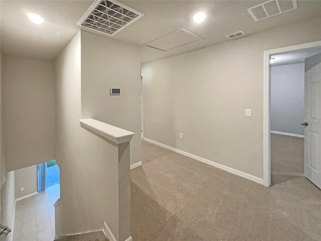 hall with attic access, an upstairs landing, and visible vents