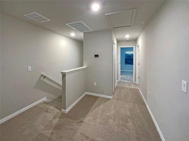 hall featuring an upstairs landing, visible vents, carpet, and baseboards