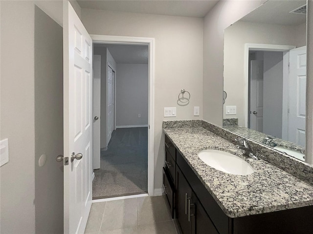 bathroom featuring vanity, baseboards, and visible vents