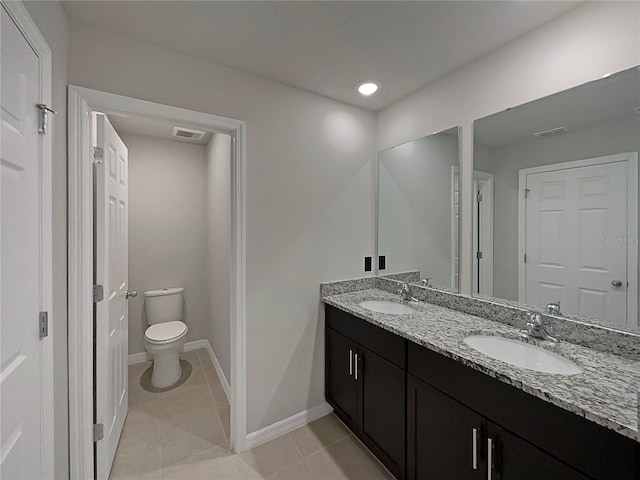 bathroom with tile patterned floors, toilet, visible vents, and a sink