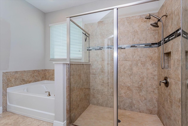 bathroom featuring a garden tub and a shower stall