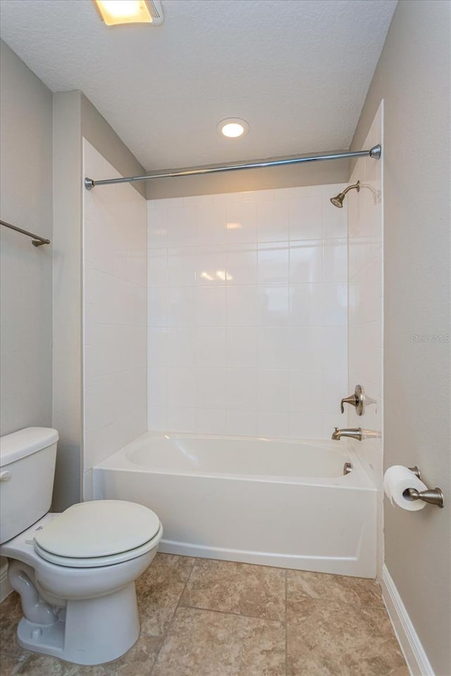 full bath with shower / bathing tub combination, baseboards, toilet, and a textured ceiling