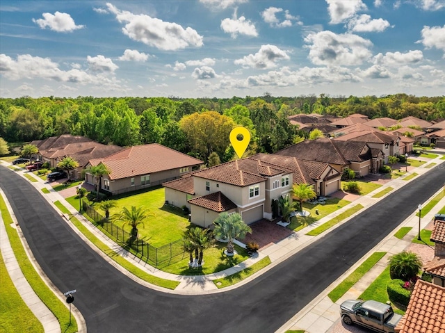 birds eye view of property featuring a residential view and a view of trees