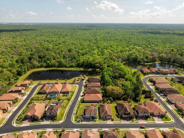 birds eye view of property with a view of trees, a water view, and a residential view