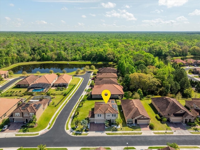 aerial view featuring a residential view, a water view, and a wooded view