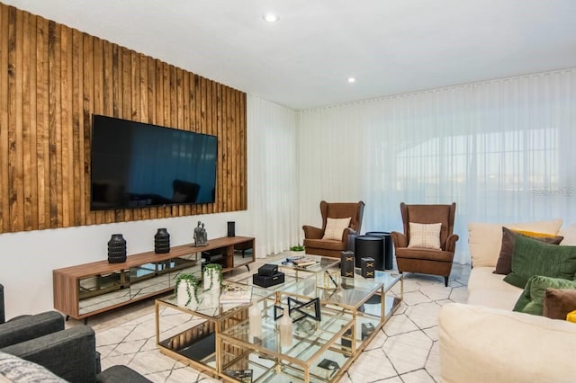 living room with wooden walls and recessed lighting