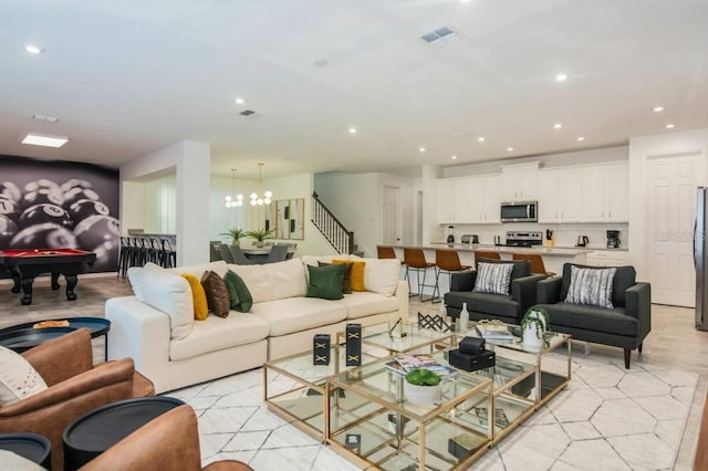 living room featuring visible vents, billiards, recessed lighting, stairway, and an inviting chandelier