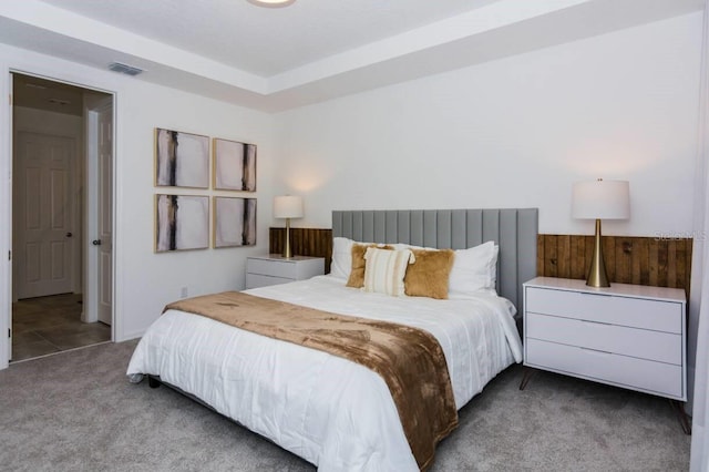 bedroom featuring carpet flooring, visible vents, and wood walls