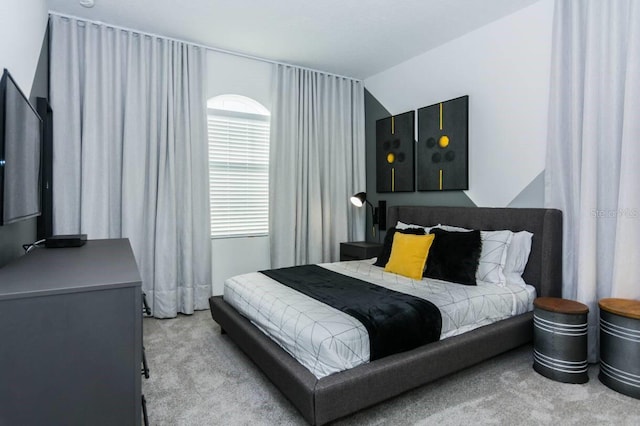 carpeted bedroom featuring lofted ceiling