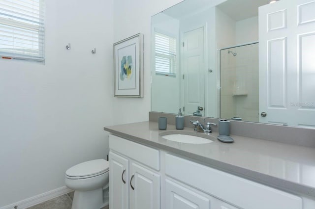 bathroom with a shower, baseboards, toilet, and vanity