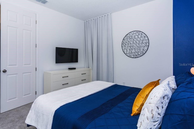 carpeted bedroom with visible vents