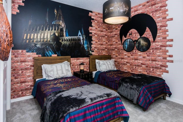 carpeted bedroom featuring baseboards, a textured ceiling, and brick wall