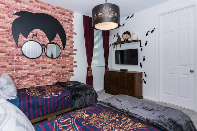 carpeted bedroom with brick wall