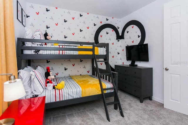 bedroom featuring wallpapered walls and carpet