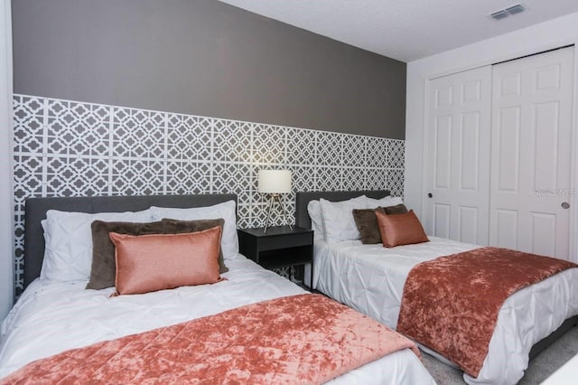 bedroom featuring visible vents and a closet