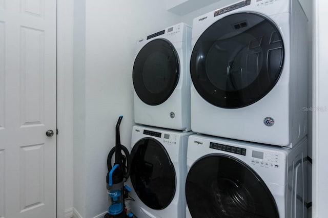 laundry area featuring stacked washer / drying machine and laundry area