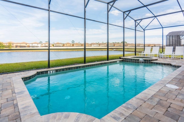 view of swimming pool featuring glass enclosure, a patio area, a water view, and a pool with connected hot tub