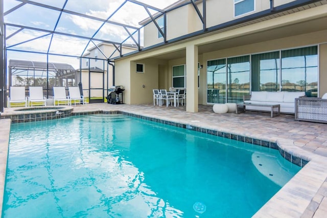 view of swimming pool featuring a patio, area for grilling, a pool with connected hot tub, and a lanai