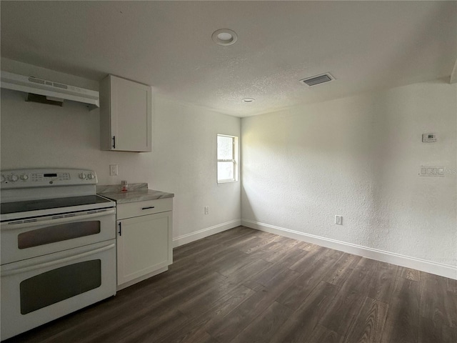 kitchen with range with two ovens, visible vents, dark wood-style floors, and white cabinetry