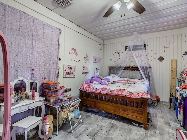 bedroom featuring visible vents, ceiling fan, and wood finished floors